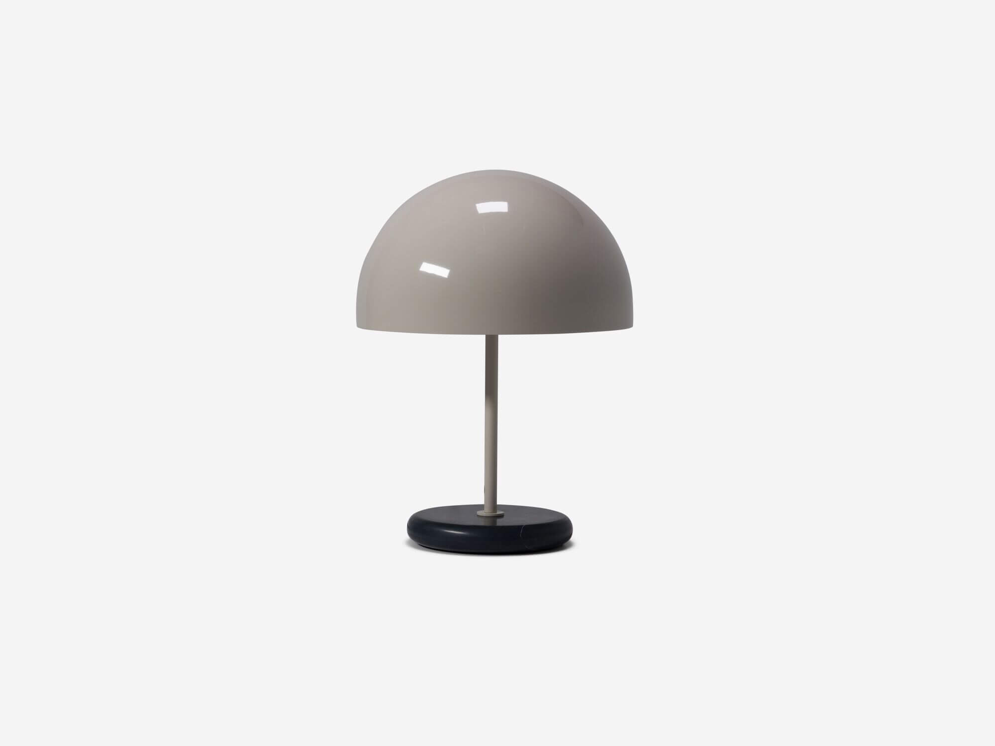 Front view of round grey shade table lamp with light off